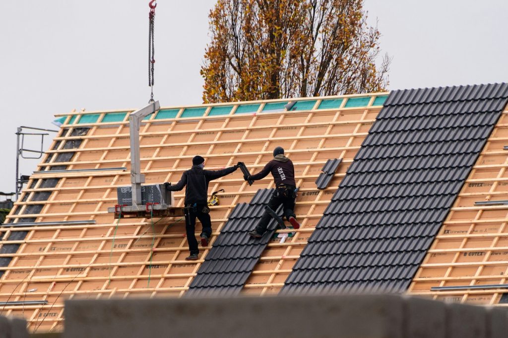 two men installing a new roof