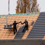 two men installing a new roof